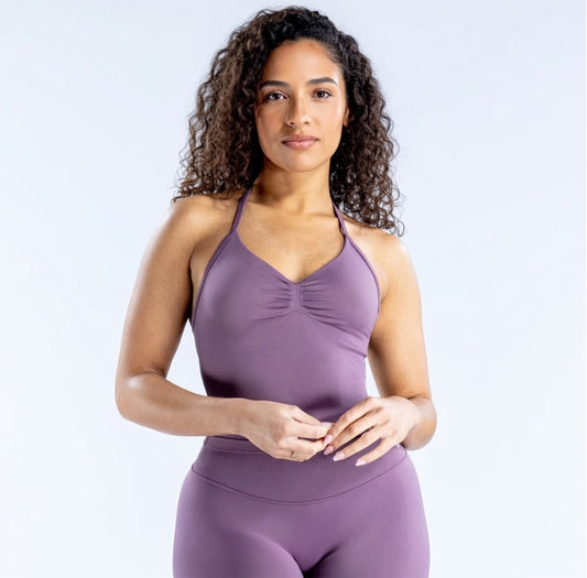 Model wearing Empower Olive Fitted Tank Top Model showcasing the Empower Grape Thistle Fitted Tank Top in a stylish pose. Model wearing Empower Scarlet Fitted TankTop Model wearing Empower Blossom Fitted Tank Top