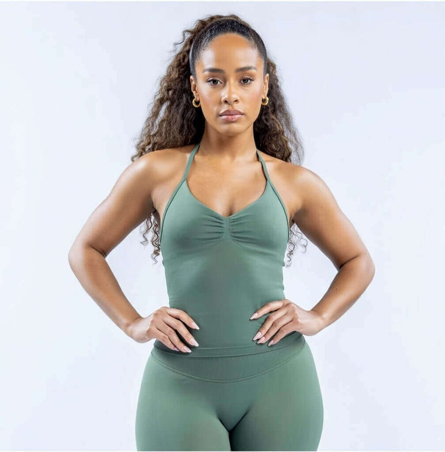 Model wearing Empower Olive Fitted Tank Top Model showcasing the Empower Grape Thistle Fitted Tank Top in a stylish pose. Model wearing Empower Scarlet Fitted TankTop Model wearing Empower Blossom Fitted Tank Top