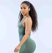 Model wearing Empower Olive Fitted Tank Top Model showcasing the Empower Grape Thistle Fitted Tank Top in a stylish pose. Model wearing Empower Scarlet Fitted TankTop Model wearing Empower Blossom Fitted Tank Top